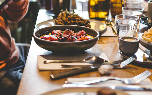 A Person Taking a Picture of Food on a Dining Table from Chrome web store to be run with OffiDocs Chromium online A Person Taking a Picture of Food on a Dining Table from Chrome web store to be run with OffiDocs Chromium online