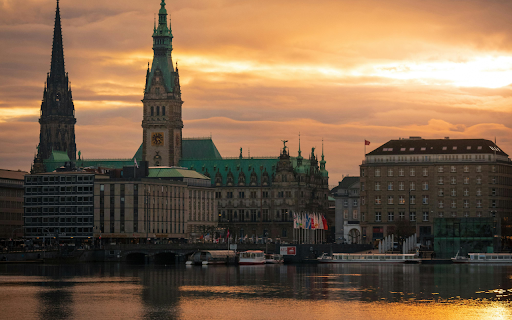 The sun sets over the water and buildings from Chrome web store to be run with OffiDocs Chromium online The sun sets over the water and buildings from Chrome web store to be run with OffiDocs Chromium online